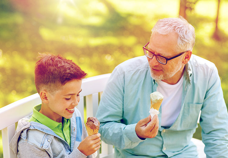 old-man-and-boy-eating-ice-cream-at-summer-park