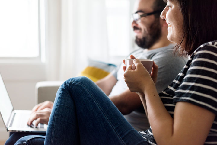 happy-couple-relaxing-at-home-P8HDEFP