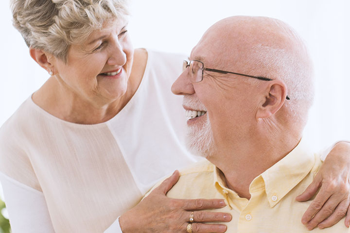 happy-grandmother-hugging-smiling-husband-P7DW54A